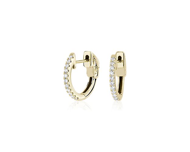 14k yellow gold frames a flawless row of diamonds on these radiant hoops that are dainty enough for daily wear. Diameter of hoop measures 5/8 Inch.