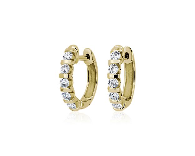 Exude elegance with these stunning hoop earrings featuring 1 ct. tw. of round-cut diamonds in ascending sizes lining the front of the hoop. These earrings are crafted from warmly lustrous 14k yellow gold and feature sleek bar accents separating each stone in art deco-inspired style.