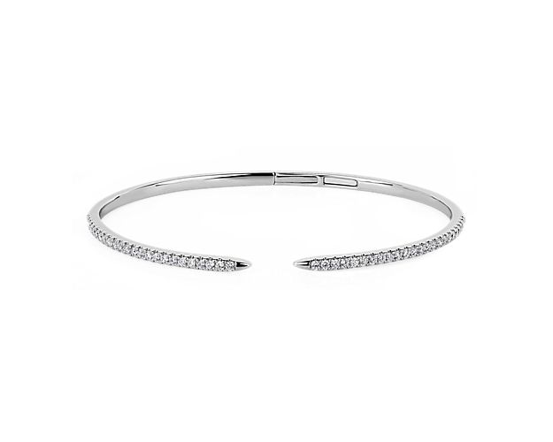 Channel simple luxury as you slip on this 14k white gold bangle featuring a sleek open claw style. The slender design is elegantly lined with sparkling diamonds that catch the light for dramatic effect.