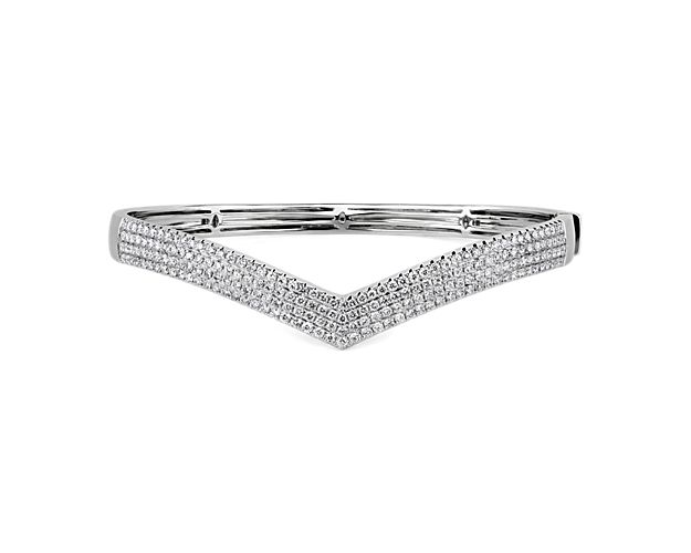 Opt for a simply luxurious look as you slip on this stunning bangle boasting pavé-set diamonds that bring brilliant sparkle to your wrist. The gracefully sweeping chevron design is crafted from gleaming 14k white gold.