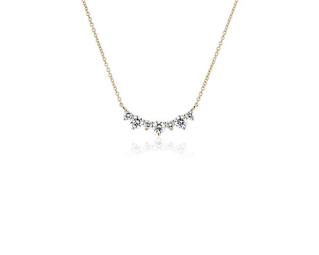 Elegantly simple, yet timelessly luxurious, this necklace features a sleek bar design in warmly gleaming 14k yellow gold. One carat total weight of diamonds brings breath-taking style to this contemporary style.
