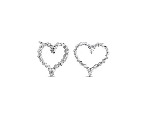 Delicate diamonds shimmer around these whimsical heart-shaped earrings, adding romantic sparkle. They feature 14k white gold design that gives them a timeless lustre.