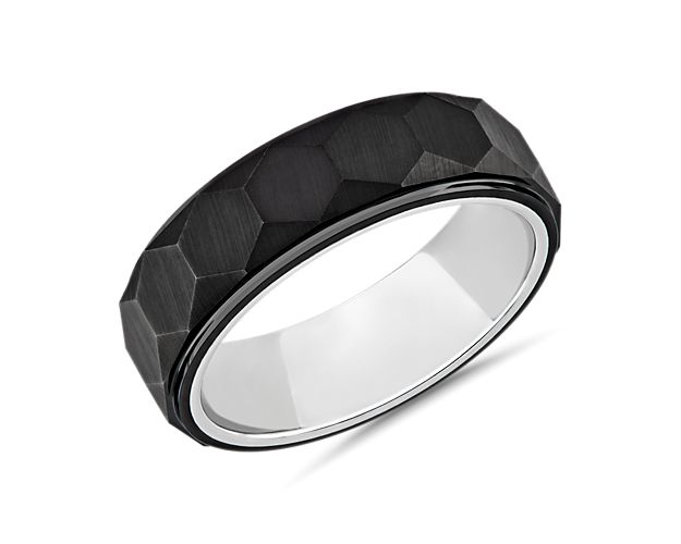 Featuring an elegantly cut design with a step edge and hexagon-shaped facets, this wedding band makes a contemporary statement. The sleek black and white tungsten design gives it handsome style.