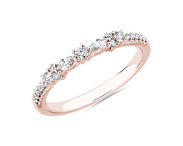 Marquise and round-cut diamonds shimmer delicately along this diamond band, giving it beautiful brilliance. It is elegantly crafted from 14k rose gold, and nestles perfectly next to its matching engagement ring, 87796.