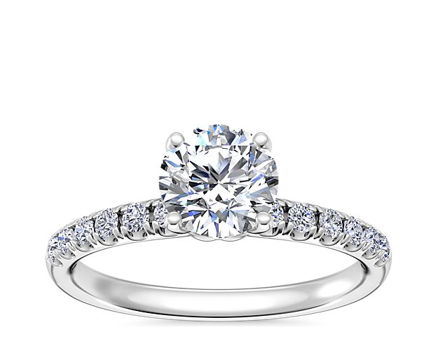 Gorgeous micropavé-set diamonds trail along the shank of this classic engagement ring, adding bold sparkle. The 14k white gold design elegantly holds the center stone aloft with elegant romance.