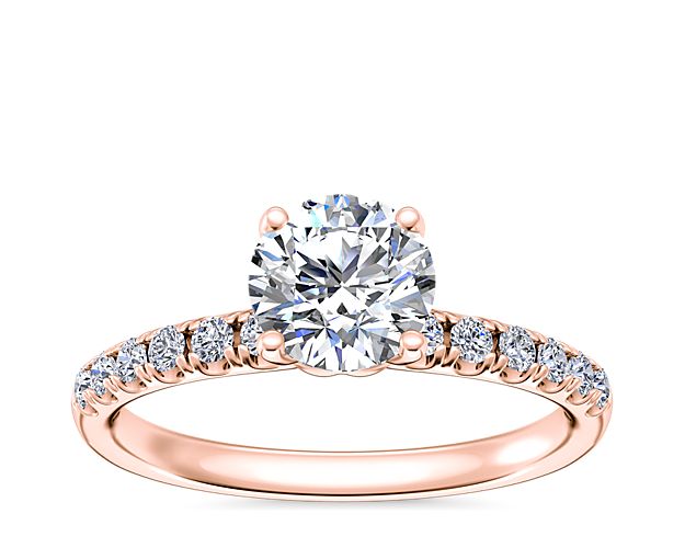 Capture the romance of the moment with this classic engagement ring crafted from warmly lustrous 14k rose gold. It features bright micropavé diamonds along the shank that emphasize the center stone with sparkle.