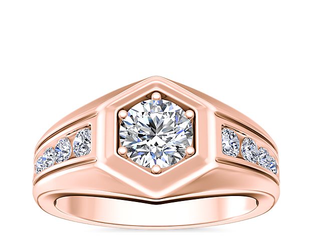 Featuring 14k rose gold design, this engagement ring boasts an eye-catching hexagonal shape that draws the eye to the round-cut center diamond. Brilliant channel-set diamonds step up the style with bold sparkle along the band.