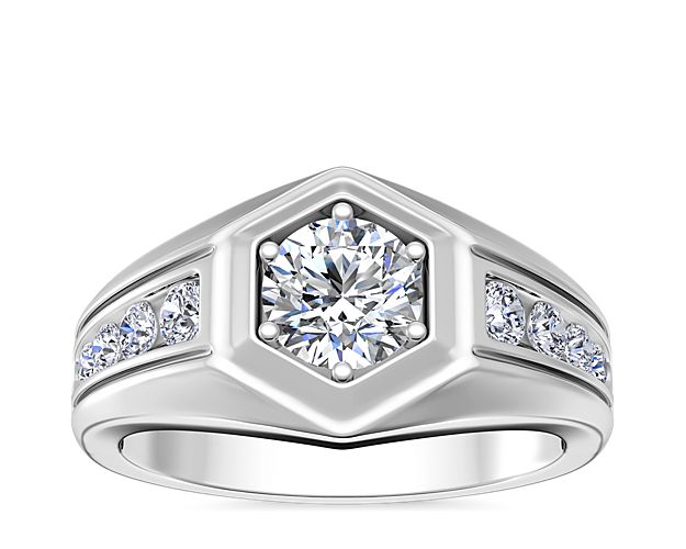 Timelessly handsome, this 18k white gold engagement ring features a statement hexagon shape framing the round-cut diamond nestled in the center setting. Channel-set diamonds lend shimmer to the band for an eye-catching effect.