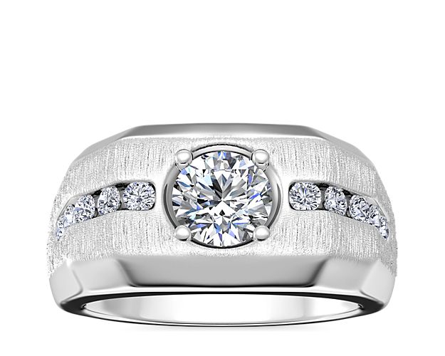 Commemorate your love story with this handsome engagement ring featuring 14k white gold design with a luxurious brushed finish. The center setting suppoorts your choice of supports round, cushion, princess (prince), emerald-cut, radiant, or oval diamond, and channel-set diamonds add a sparkling accent.