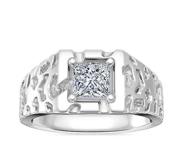 This handsome engagement ring features a center setting that supports a round, princess (prince), radiant, or emerald-cut diamond. The lustrous 14k white gold design is beautifully highlighted by the unique 'gold nugget' texture.