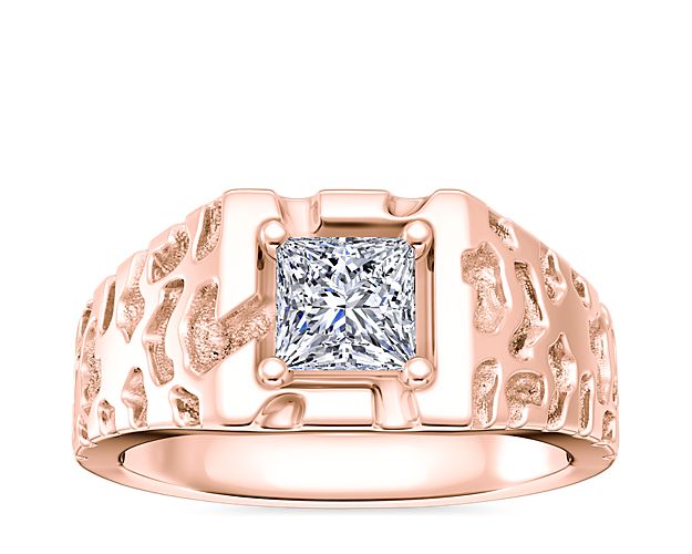 Featuring warmly lustrous 18k rose gold design, this enagement ring is finished with a unique 'gold nugget' texture. The center stone can be a round, princess (prince), radiant, or emerald-cut diamond to complete it with brilliant sparkle.