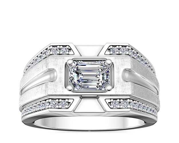 Handsome 14k white gold engagement ring featuring grooved design, with channel-set diamonds sparkling along the outer edges. The east-west set center stone completes it with bold elegance.