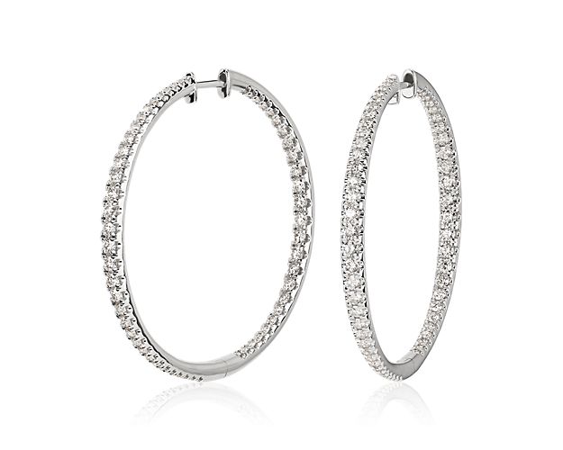 Elevate your elegance with these classic large hoop earrings featuring shimmering pave-set diamonds sparkling along the front-facing edges. The lustrous 14k white gold design promises enduring quality and shine. Diameter of hoop measures 1 1/2 Inches.