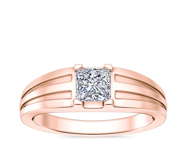 Love shines brilliantly from this engagement ring featuring an elegant center setting that  supports princess (prince), emerald-cut, and radiant-cut diamonds. The lustrous 14k rose gold design features beautifully tapered and grooved stylings along the band.
