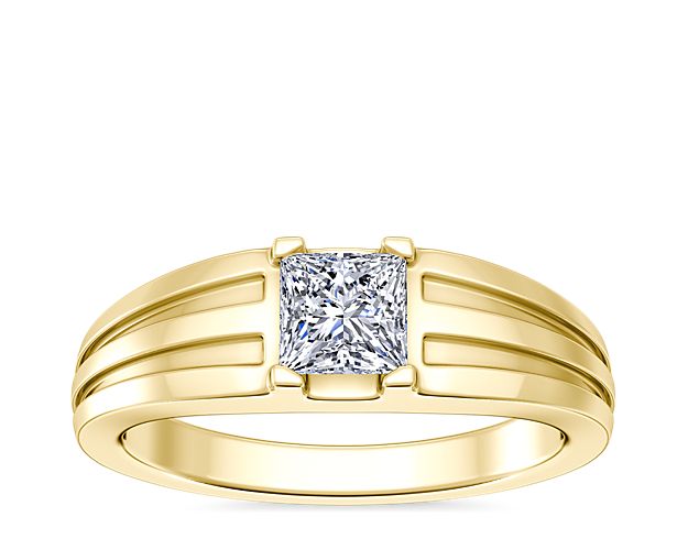 Love shines brilliantly from this engagement ring featuring an elegant center setting that  supports princess (prince), emerald-cut, and radiant-cut diamonds. The lustrous 18k yellow gold design features beautifully tapered and grooved stylings along the band.