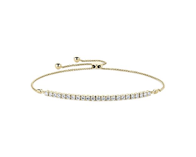 Add a touch of luxurious shimmer to your wrist with this bolo bracelet featuring shimmering round-cut diamonds and a comfortably adjustable design. The 14k yellow gold design is elegantly crafted and promises a warmly luxurious look.