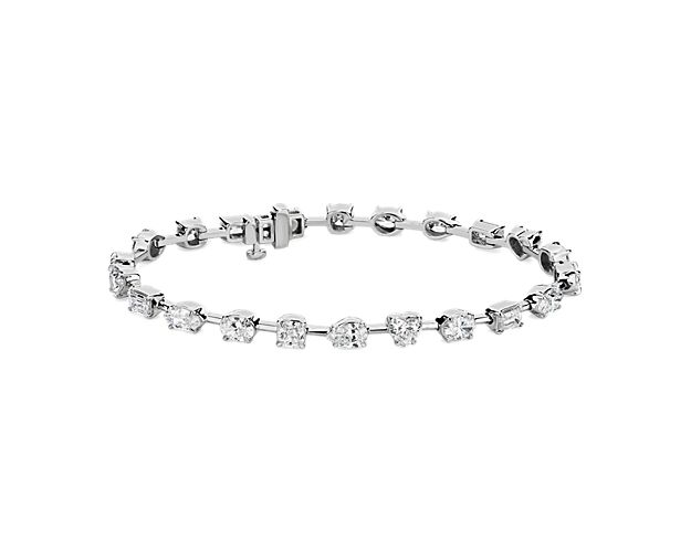 Catch their eye as you wear this tennis bracelet featuring elegantly spaced diamonds in a variety of cuts to add sparkling intrigue. The cool lustre of the 18k white gold complements the stones with a luxurious look of quality.