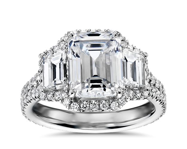 Brilliance defined. A pair of trapezoid side diamonds frame the emerald-cut center stone of your choice in this timeless and breathtaking platinum engagement ring. For center stones 1.5  to 3 carats.