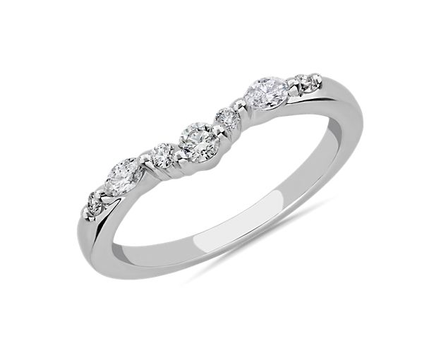 A symbol of beautiful love, this curved wedding ring is artfully crafted from 18k white gold, which promises a cool luster. A cluster of marquise-cut and round-cut diamonds add sparkle to match your engagement ring.