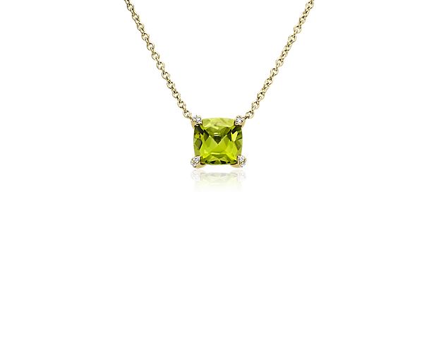 Complete your look with this simple, yet sophisticated pendant boasting a shimmering cushion-cut peridot flaunting a vivid hue. The 14k yellow gold design promises a luxurious warm luster, and features accent diamonds sparkling brightly along the corner prongs holding the center stone.