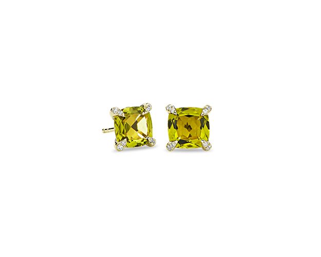 Add a hint of mesmerizing sparkle to your style with these shimmering green cushion-cut peridot stud earrings. The 14k yellow gold design features accent diamonds set in the prongs around the peridots, adding a glamorous finish.
