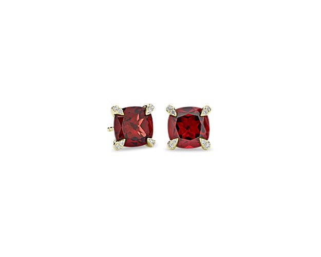 Channel regal allure with these stud earrings set with cushion-cut garnets that boast mesmerizing red hues. The warm lustre of the 14k yellow gold setting beautifully complements the dramatic tone of the stones, and accent diamonds bring alluring shimmer to the prongs.