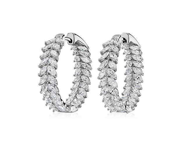 Two columns of marquise-cut diamonds sparkle side-by-side, creating a breathtaking effect as these hoop earrings catch the light. Gleaming 14k white gold design features a cool lustre that complements the stones. Diameter of hoop measures 15/16 Inch.