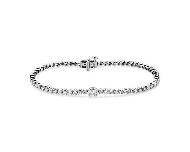 Accent your wrist with dramatic sparkle when you wear this shimmering tennis bracelet, featuring 3 ct. tw. of diamonds sparkling along it, with a single oval-cut diamond at its centre. The 14k white gold promises enduring beauty and quality.