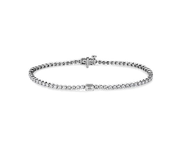 Elevate your style with the sparkle of this brilliant tennis bracelet featuring 14k white gold design. It is set with fiery round-cut diamonds, with a gorgeous emerald-cut accent diamond at the middle.