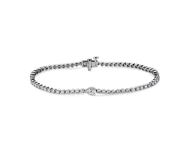 Go for a look of classic sophistication with this tennis bracelet featuring brilliant round-cut diamonds lining it, and a stunning pear-cut accent diamond adding elegant detail. The 14k white gold design promises lasting luxury.