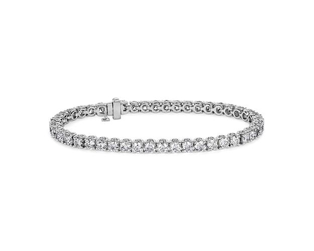 Adorn your wrist with this classically elegant tennis bracelet featuring stunning diamonds shimmering along its length. The rollover design is crafted in brightly lustrous 14k white gold to complete the luxurious look.