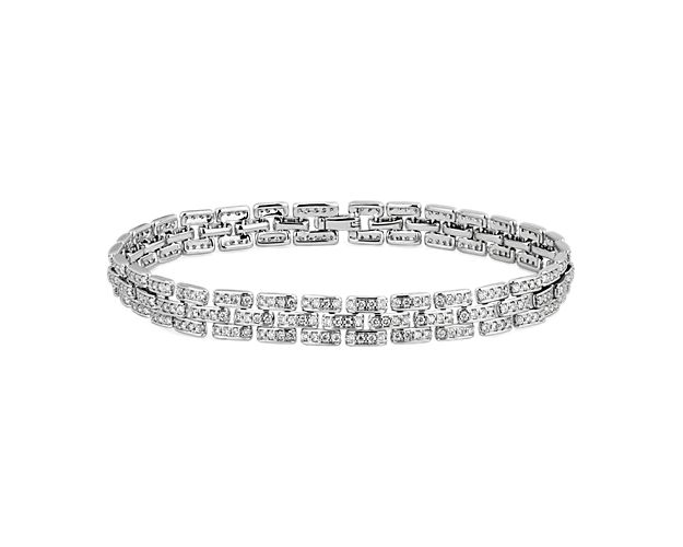Delicate diamonds shimmer from each link of this mesmerizing bracelet. It is artfully crafted from cooly lustrous 14k white gold for a look of timeless luxury.