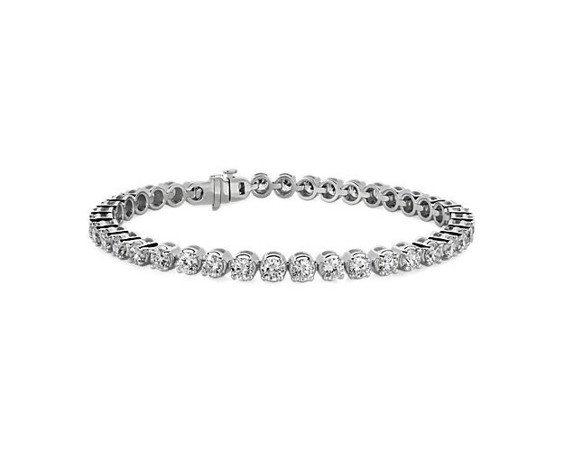 Beautifully crafted, this tennis bracelet features sparkling round brilliant cut lab-grown diamonds that are set in a classic four-prong straight line design of 14k white gold.