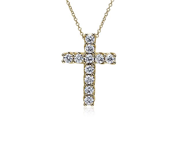 Shimmering diamonds bring breath-taking sparkle to this classic cross pendant. It is artfully crafted from 14k yellow gold that promises a warm lustre and enduring quality.
