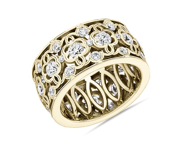 Proclaim romance with this mesmerizing eternity ring featuring a beautifully detailed clover lace pattern crafted from 18k yellow gold. It is intricately set with shimmering diamonds to capture the eye with plenty of sparkle.