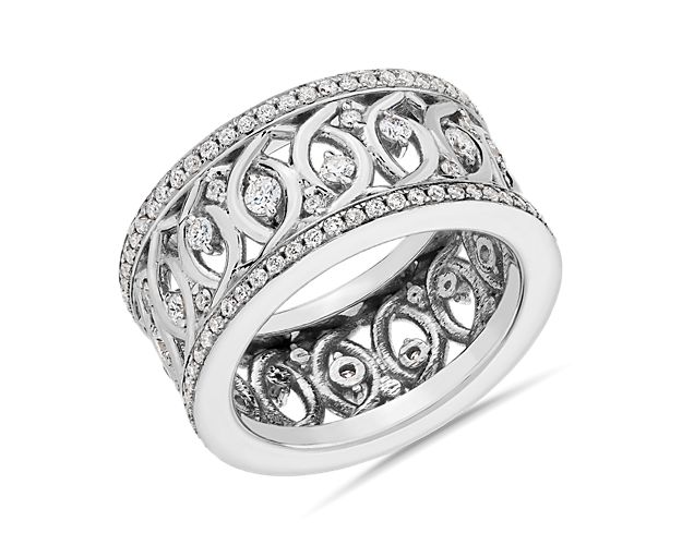 This vintage-inspired eternity ring features an intricate openwork pattern crafted from luxurious 18k white gold. Shimmering diamonds are delicately set in the eye-catching design to add sparkle.