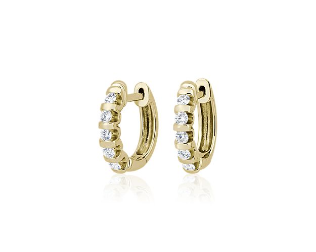 A row of diamonds in ascending sizes runs along the front of each of these elegant hoop earrings, adding 1/2 ct.tw. of sparkle to your style. The 14k yellow gold design features sleek bar accents between each stone for a contemporary statement with a hint of art deco allure.