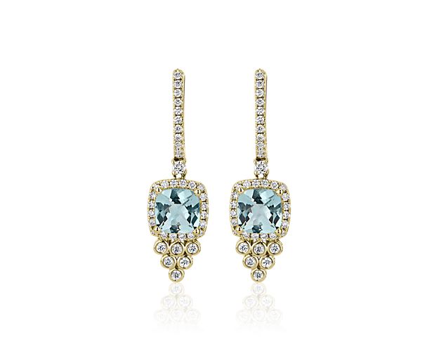 Turn heads in these drop earrings set with gorgeous blue aquamarine stones and crafted from warmly lustrous 14k yellow gold. Diamond accent drops shimmer below for a dramatic effect.