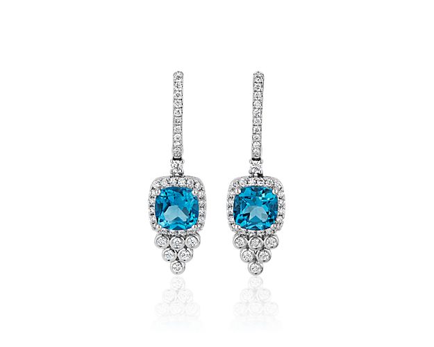 Go for a dramatic look in these bold drop earrings set with Swiss blue topaz and accented by delicately cascading diamonds drops below. It is crafted from 14k white gold for timelessly luxurious style.