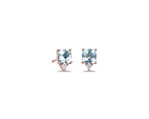 Dreamy blue cushion-cut aquamarines draw the eye to these stunning stud earrings. They each feature a delicate accent drop diamond and lustrous 14k rose gold design.