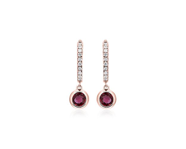 Look regal whenever you wear these hoop earrings crafted from warmly lustrous 14k rose gold. The front edge sparkles with delicately set diamonds, and a deep red round-cut ruby dangles from each one, adding a luxurious finish.