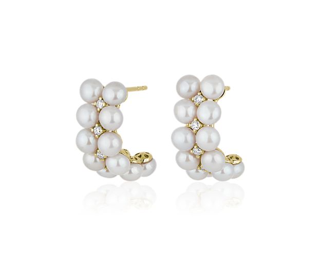 Two rows of lustrous freshwater pearls run along the front of these timelessly charming hoop earrings. They are crafted from 14k yellow gold for an everlasting luxurious look.