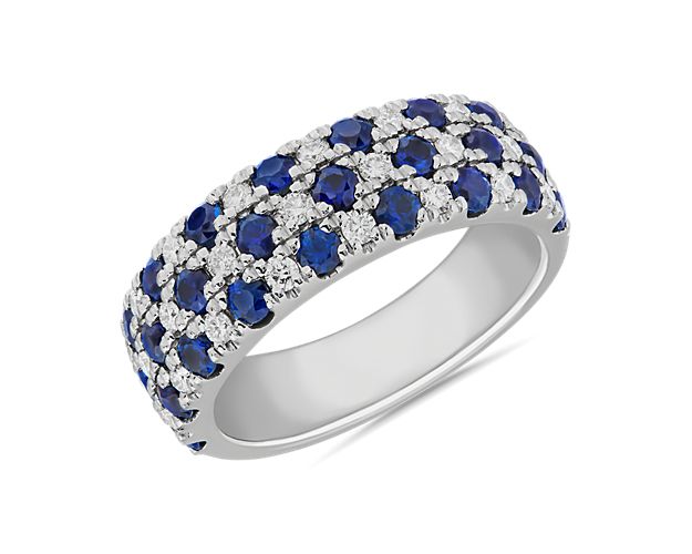 Three rows of alternating sapphires and diamonds bring dramatic sparkle and color to this bold ring. It features a cooly lustrous 14k white gold design.