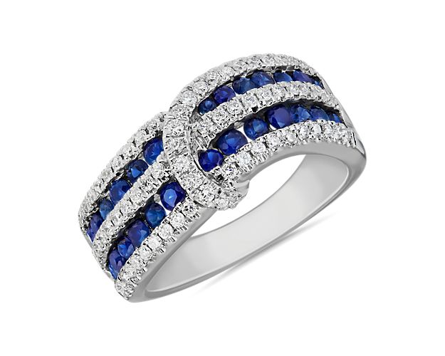 Dramatic deep sapphires and fiery diamonds nestle side-by-side in this layered ring featuring a twisting diamond sash. It is artfully crafted from 14k white gold.
