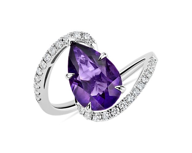 Accent your finger with this elegant ring featuring a dreamy purple pear-cut amethyst stone held gracefully by the entwining 14k white gold band. Shimmering  diamonds add dramatic sparkle to the twisting shanks for a mesmerizing effect.