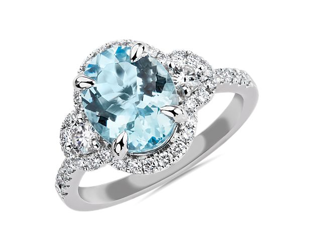 Add sparkle to your hand with this dramatic statement ring featuring a bold oval-cut aquamarine stone at the centre, flanked by two accent diamonds. The lustrous 14k white gold design promises lasting quality.