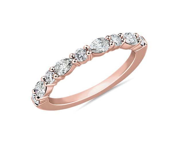 Express eternal romance with this simple and sophisticated wedding ring beautifully crafted in luxurious 14k rose gold. An array of round-cut and pear-cut diamonds sit elegantly, promising eye-catching brilliance.