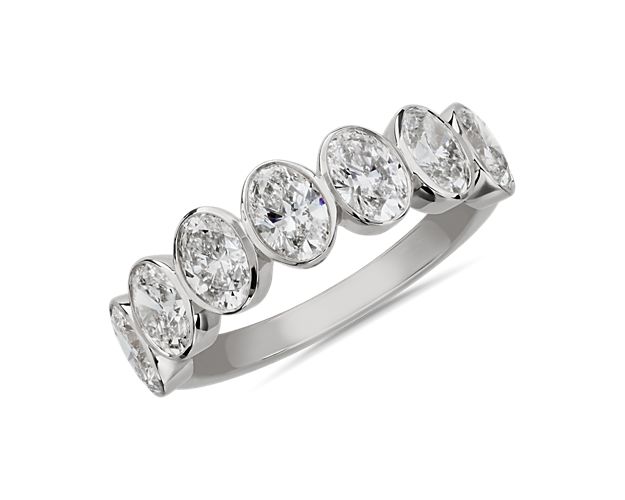 Mesmerize the eye with this stunning anniversary band featuring seven oval-cut diamonds that bring vintage-inspired art-deco charm. The beautiful bevel setting is crafted from 14k white gold that promises a romantic bright gleam.