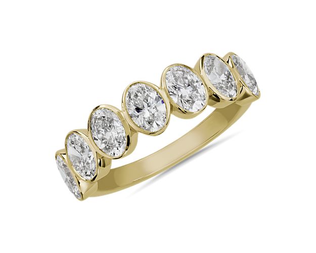 Mesmerize the eye with this stunning anniversary band featuring seven oval-cut diamonds that bring vintage-inspired art-deco charm. The beautiful bevel setting is crafted from 14k yellow gold that promises a romantic bright gleam.