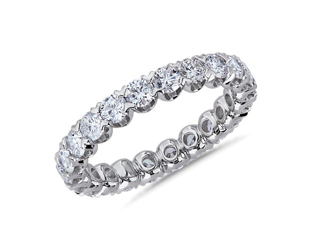 Brilliant diamonds endlessly encircle this stunning eternity ring crafted from 14k white gold. The V-prong pavé settings highlight the stones in elegantly contemporary style.